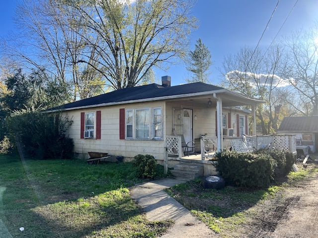 view of front of home featuring cooling unit and a front lawn