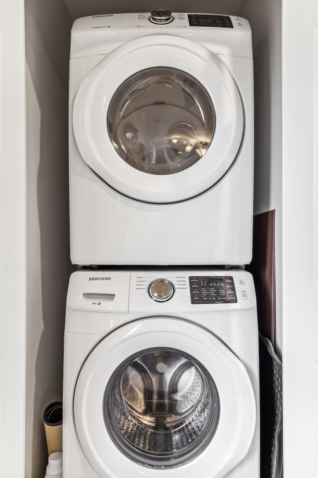 laundry area featuring stacked washer and clothes dryer