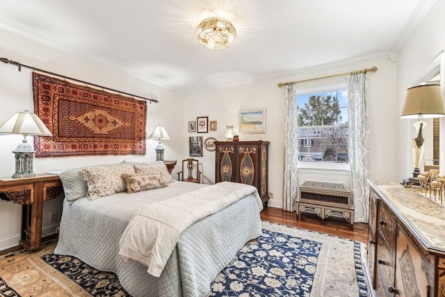 bedroom featuring hardwood / wood-style floors and ornamental molding