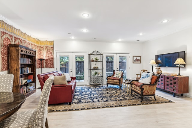 living room with french doors, light hardwood / wood-style flooring, and ornamental molding