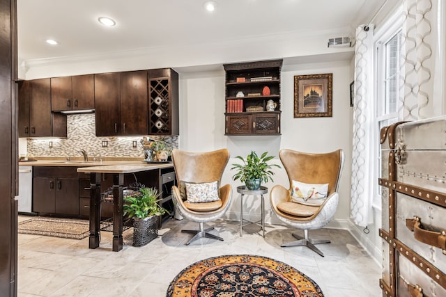 interior space with beverage cooler, ornamental molding, and sink