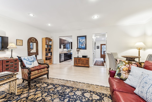 living room featuring light hardwood / wood-style flooring and ornamental molding