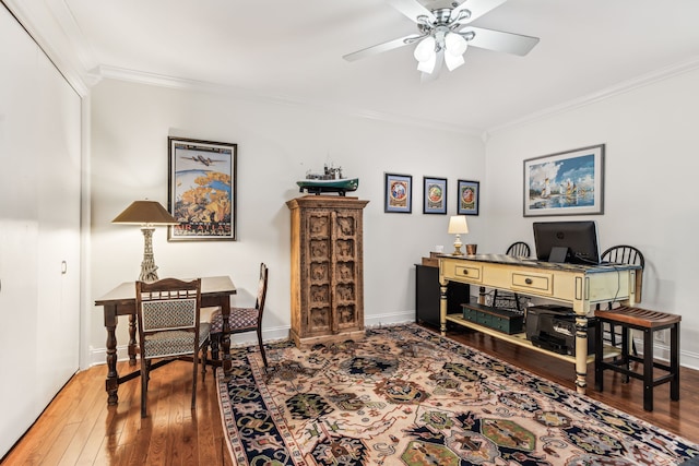 office space featuring wood-type flooring, ceiling fan, and crown molding