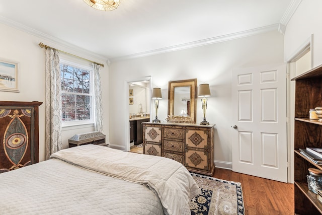 bedroom featuring ensuite bathroom, sink, wood-type flooring, and crown molding