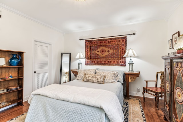 bedroom featuring wood-type flooring, a closet, and crown molding