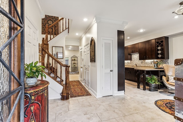 foyer with ornamental molding and sink