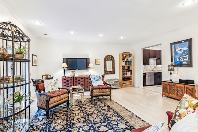 living room featuring crown molding and light hardwood / wood-style floors