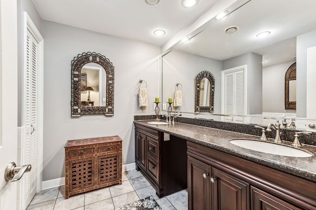 bathroom with tile patterned floors and vanity