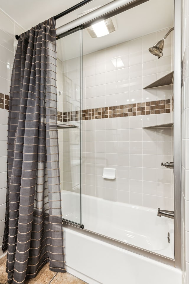 bathroom featuring tile patterned floors and shower / tub combo with curtain