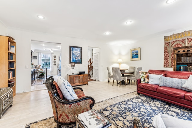 living room featuring ornamental molding and light wood-type flooring