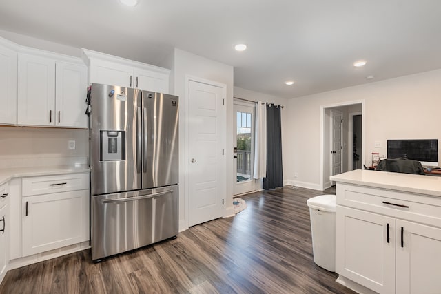 kitchen with white cabinets, dark hardwood / wood-style floors, and stainless steel fridge with ice dispenser