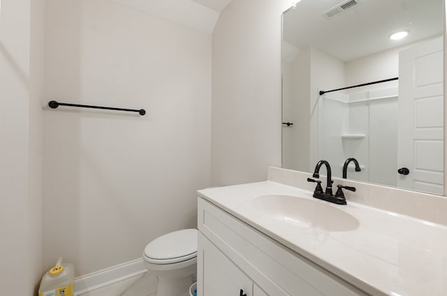 bathroom with tile patterned floors, vanity, toilet, and a shower