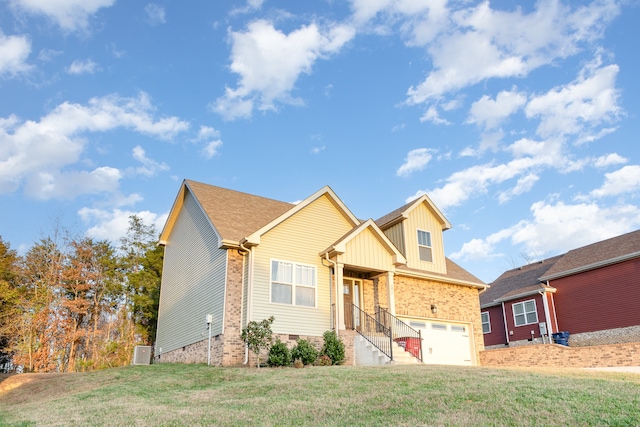 view of front of home with cooling unit, a garage, and a front yard