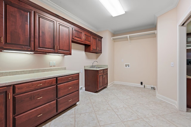 clothes washing area featuring hookup for a washing machine, crown molding, sink, and cabinets