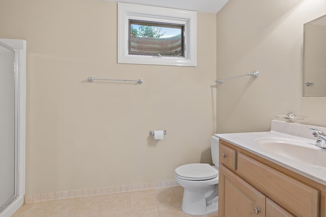 bathroom with tile patterned flooring, vanity, toilet, and a shower with shower door