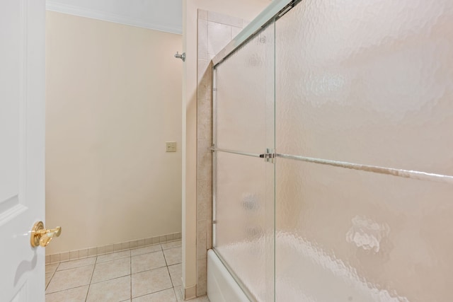 bathroom featuring tile patterned floors, shower / bath combination with glass door, and ornamental molding