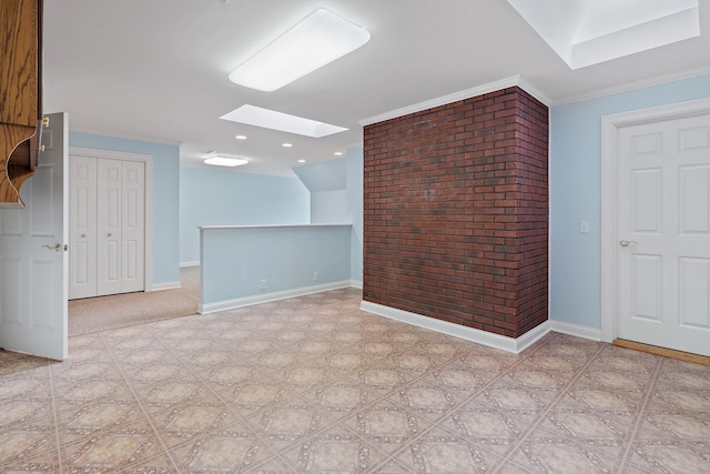 interior space with a skylight and ornamental molding