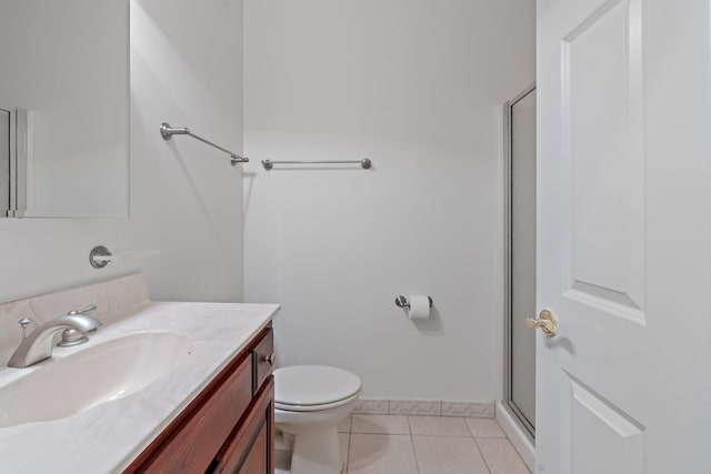 bathroom featuring tile patterned floors, walk in shower, vanity, and toilet