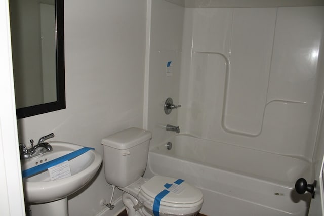 full bathroom featuring toilet, sink, and washtub / shower combination