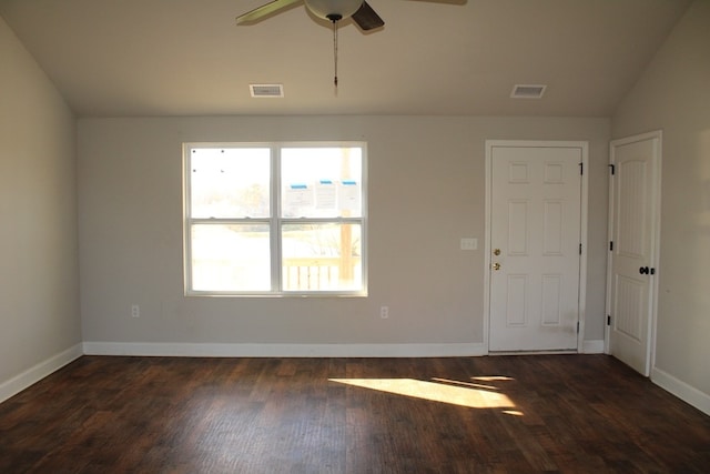 unfurnished room featuring lofted ceiling, dark hardwood / wood-style flooring, and ceiling fan