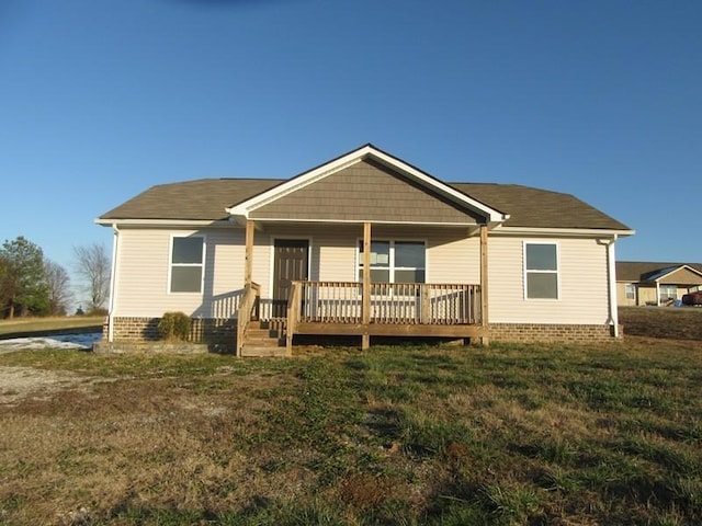 rear view of house featuring a yard