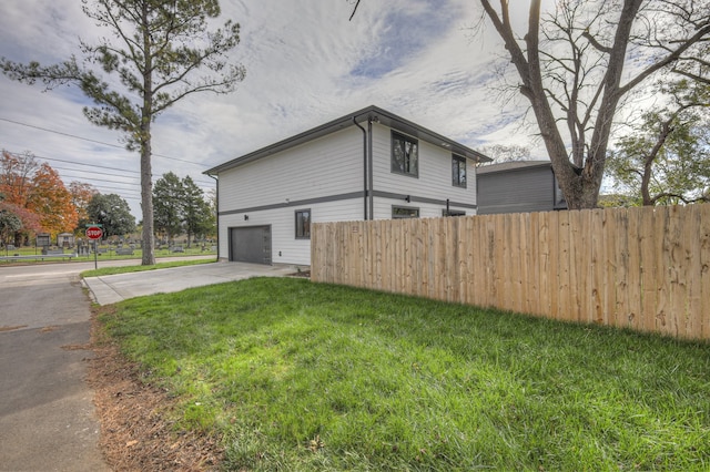 view of home's exterior featuring a garage and a lawn