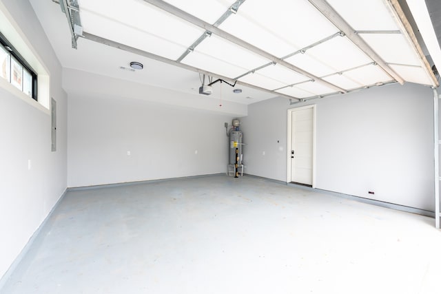 garage with electric panel, gas water heater, and a garage door opener