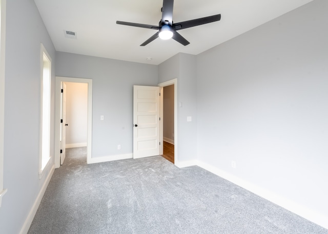 unfurnished bedroom featuring ceiling fan and carpet floors