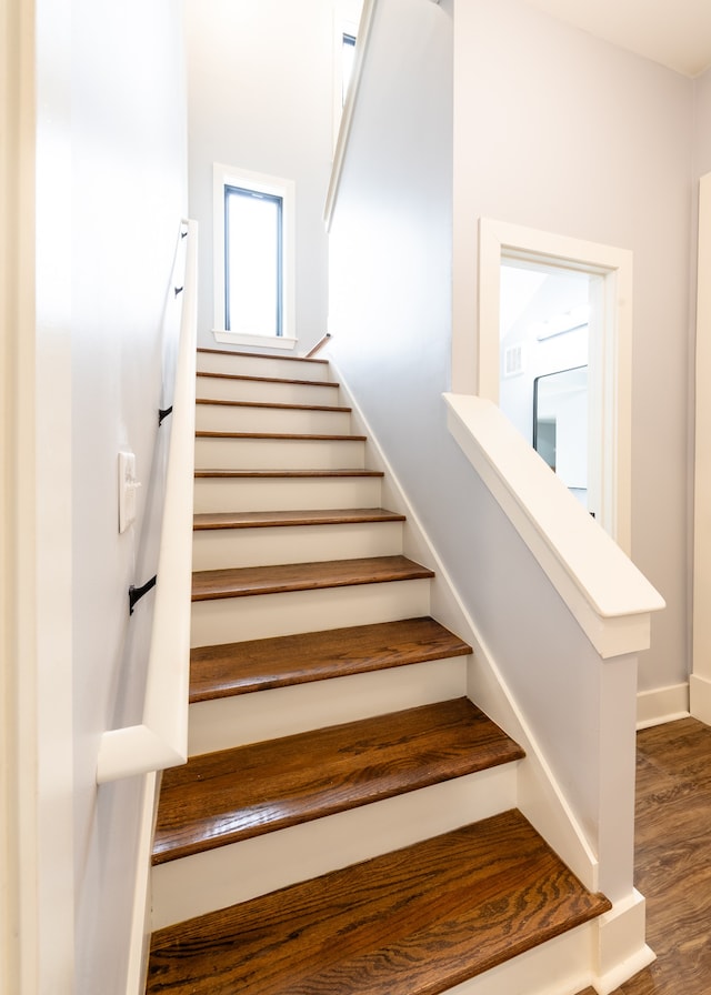 staircase with hardwood / wood-style floors