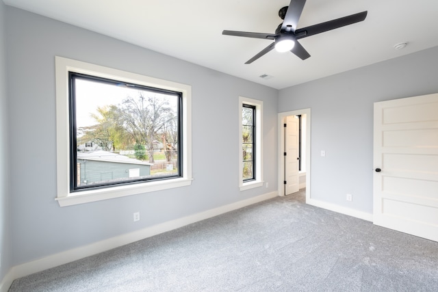 unfurnished bedroom featuring ceiling fan and carpet