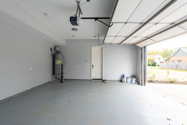 garage with electric water heater and a garage door opener