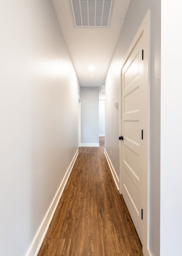 hallway with dark hardwood / wood-style flooring