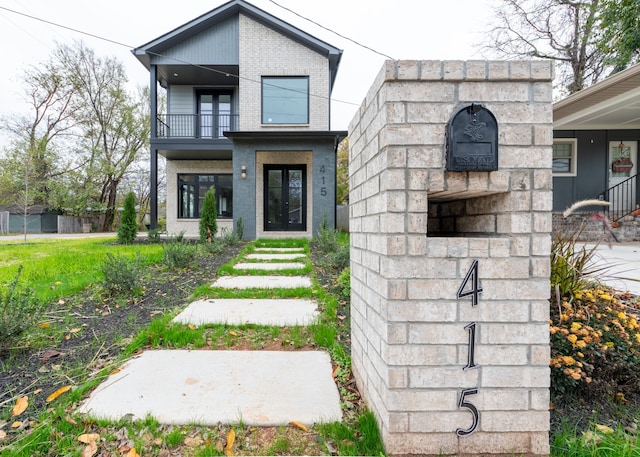 view of front of property featuring french doors and a balcony