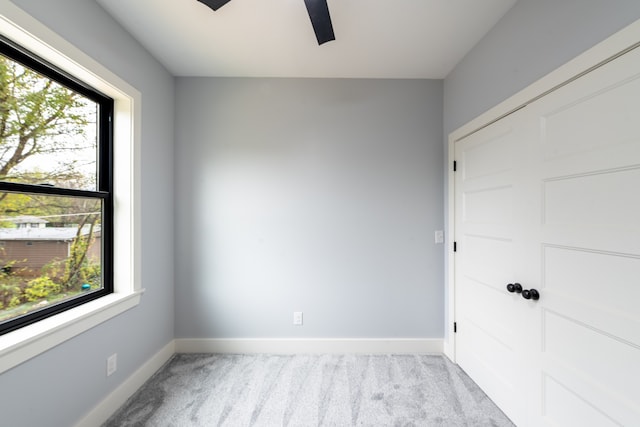 unfurnished room featuring light colored carpet and a healthy amount of sunlight