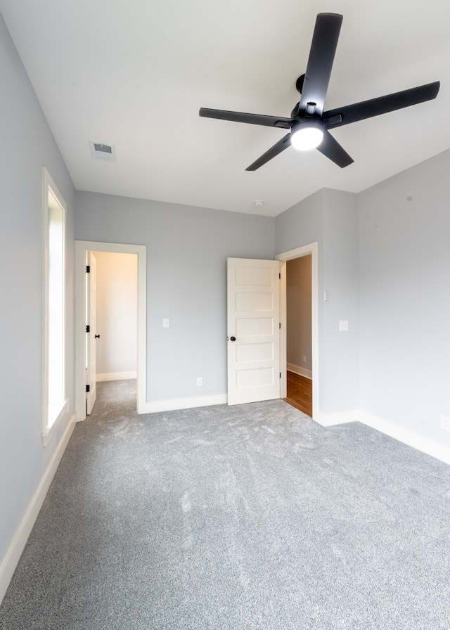 unfurnished bedroom with carpet flooring and ceiling fan