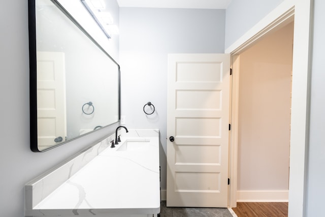 bathroom with vanity and wood-type flooring