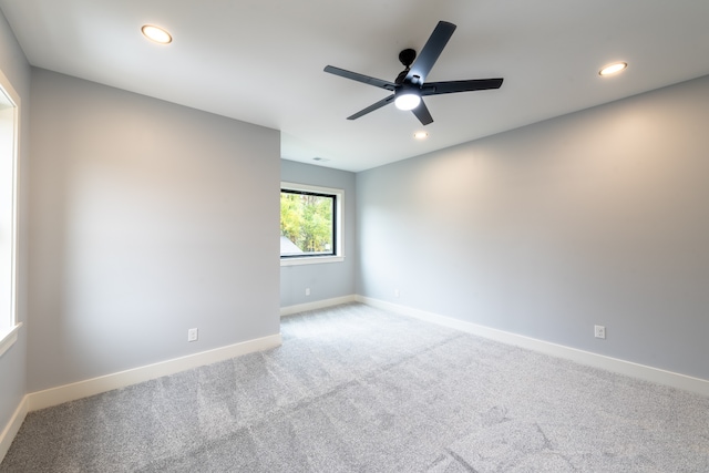 carpeted empty room featuring ceiling fan