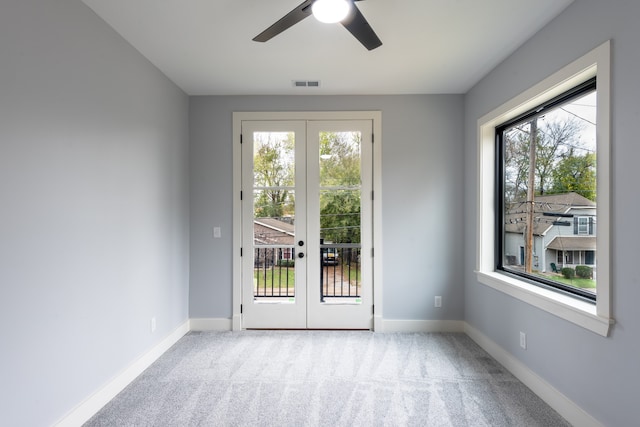 doorway featuring ceiling fan, french doors, light colored carpet, and plenty of natural light