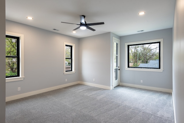 carpeted empty room featuring ceiling fan