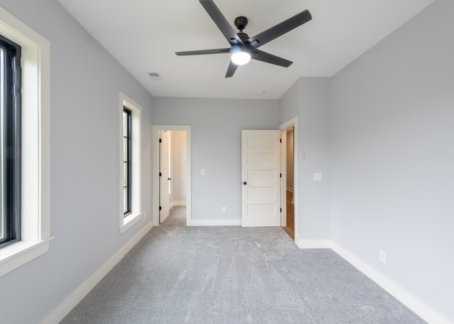 unfurnished bedroom with ceiling fan and light carpet