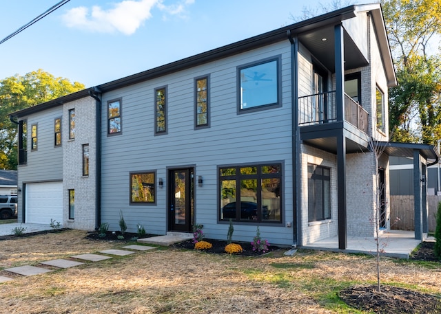 view of front of house featuring a balcony and a garage