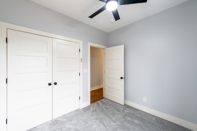 unfurnished bedroom featuring carpet flooring, ceiling fan, and a closet