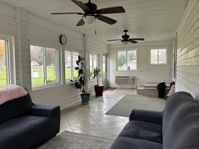 sunroom with a wall unit AC, ceiling fan, and a healthy amount of sunlight