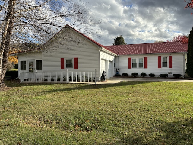 back of house with a lawn and a garage