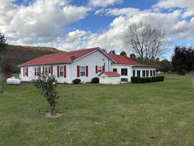 view of side of property with a yard