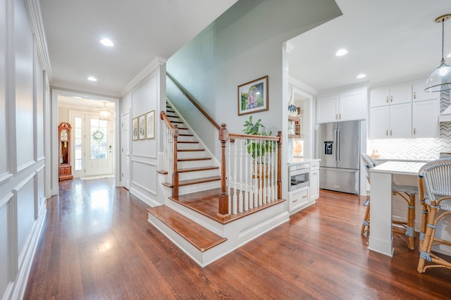 interior space with dark hardwood / wood-style floors and ornamental molding