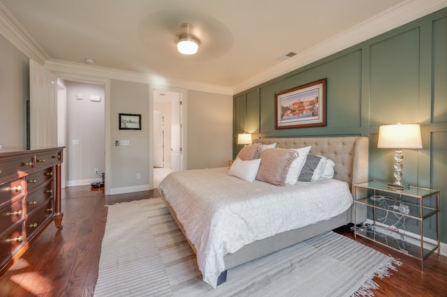 bedroom featuring ensuite bath, ceiling fan, dark hardwood / wood-style flooring, and ornamental molding