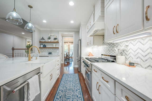 kitchen featuring light stone countertops, appliances with stainless steel finishes, dark hardwood / wood-style flooring, pendant lighting, and white cabinetry