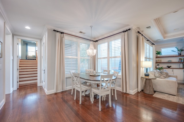 dining area with crown molding, dark hardwood / wood-style floors, and an inviting chandelier