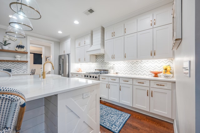 kitchen with white cabinetry, light stone counters, dark hardwood / wood-style floors, custom range hood, and appliances with stainless steel finishes